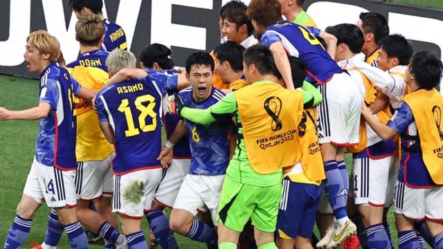 Japanese players celebrate after scoring