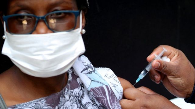 A woman is vaccinated in South Africa.