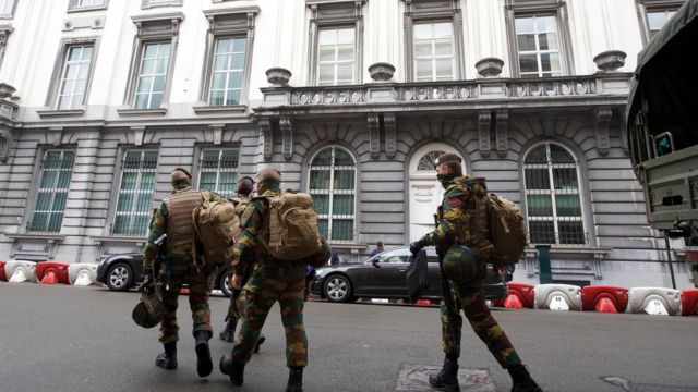 Belgian soldiers walk the streets after counter-terror raids.