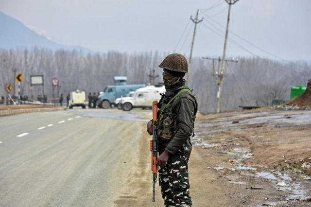 A paramilitary trooper seen standing guard close to the site of the blast, about 28kms from Srinagar.