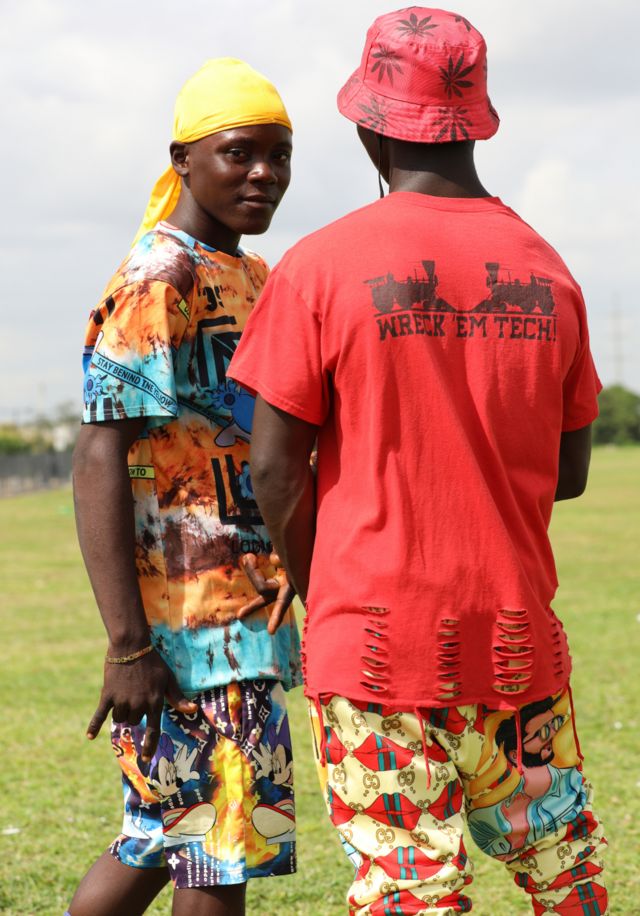 Two Fulani men in red and yellow clothes