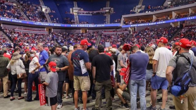 Supporters of U.S. President Donald Trump wait for him to appear onstage 27 minutes before the scheduled start of his speech, at his first re-election campaign rally in several months in the midst of the coronavirus disease (COVID-19) outbreak,