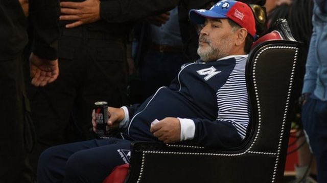 Maradona sits in a throne presented to him