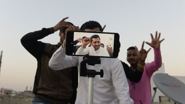 Young Indian men making a TikTok video in Hyderabad.