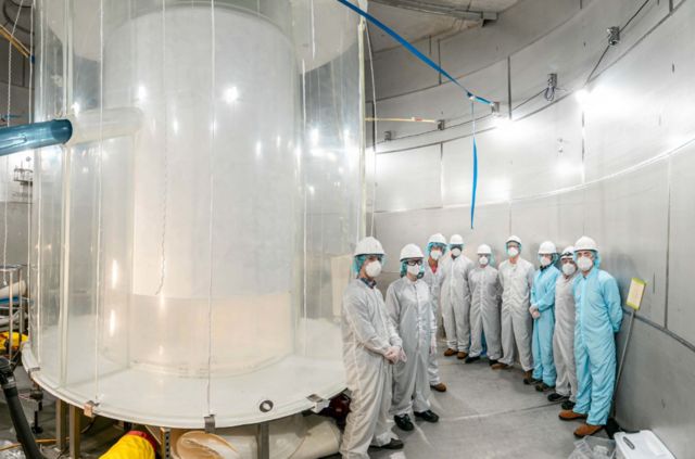 Some of a team of 250 scientists took pictures with an LC machine inside a pond that would hold the purified water.