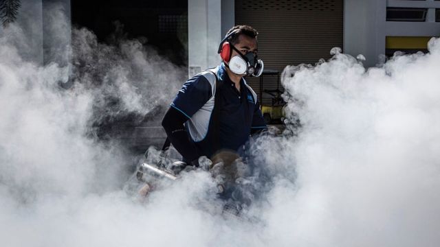 蚊が繁殖しやすい場所を燻蒸消毒するシンガポールの衛生部局職員(先月3日)