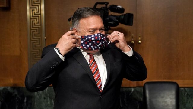 US Secretary of State Mike Pompeo puts on a face mask