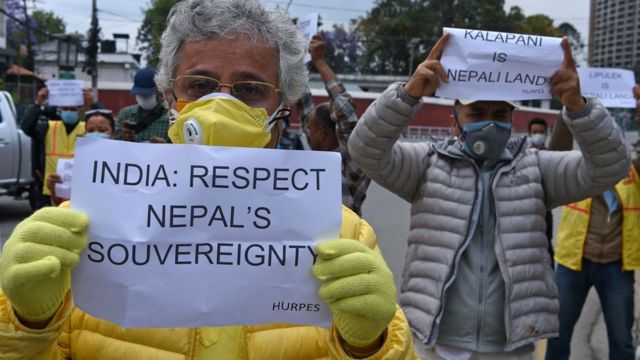 Human rights activists hold placards during a protest against India's newly inaugurated link road to the Chinese border, near Indian embassy in Kathmandu on May 12, 2020.