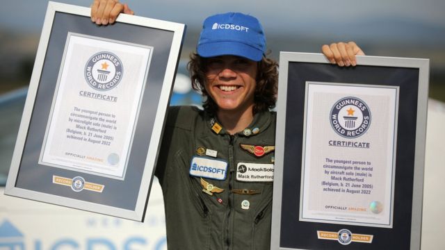 Mack Rutherford holding his two Guinness World Record certificates