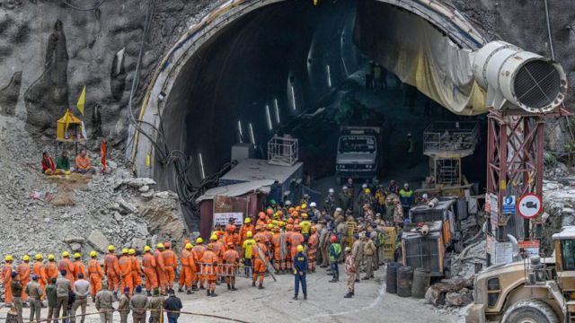 National Disaster Response Force (NDRF) personnel along with other rescue operatives gather near the face of the collapsed under construction Silkyara tunnel in the Uttarkashi district of India's Uttarakhand state, on November 28, 2023