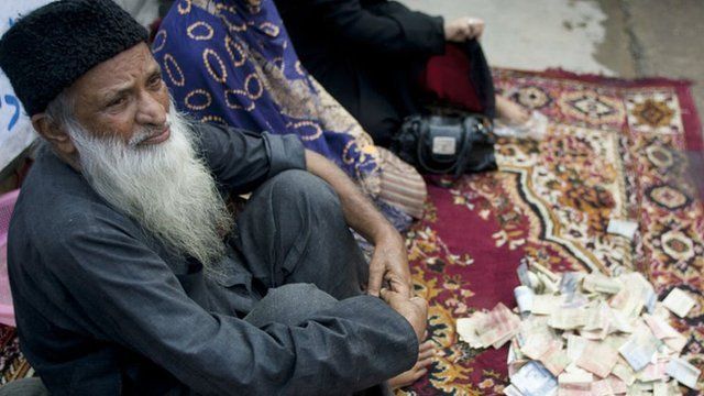 Abdul Sattar Edhi collects donations at a roadside in Peshawar, Pakistan, in 2010