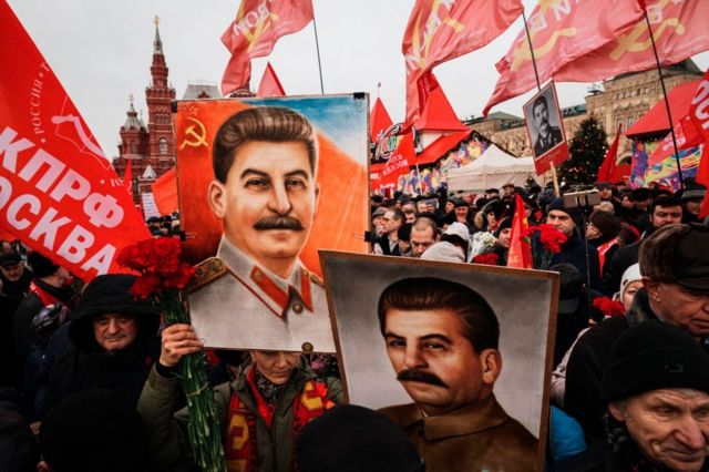 Protesters hold signs of Soviet leader Joseph Stalin at a Moscow demonstration in 2019.