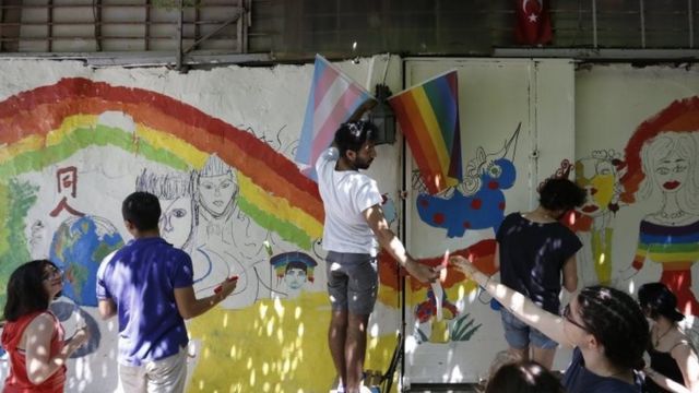 Activists paint rainbow paintings before the annual march