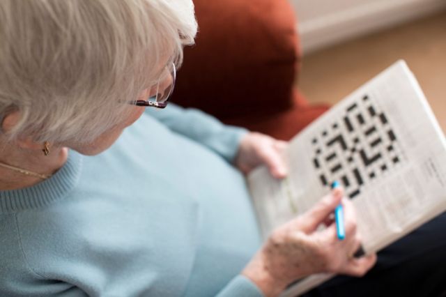 woman with a crossword puzzle