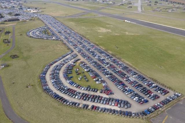 Вид сверху на ряды автомшин на летном поле