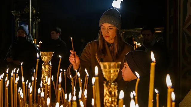 Candle lit during Christmas Eve service Kyiv Ukraine