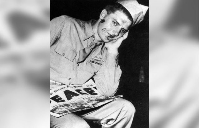 An American soldier is seen with lipstick marks on his face