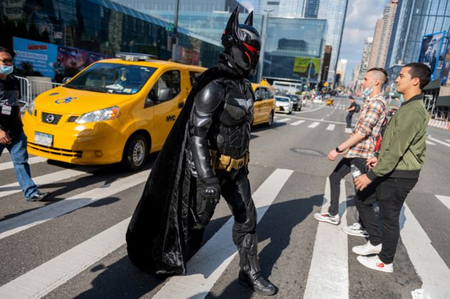 A cosplayer dressed as Batman wearing the Hellbat suit crosses the road during Day 1 of New York Comic Con at Javits Center on 7 October 2021 in New York City.