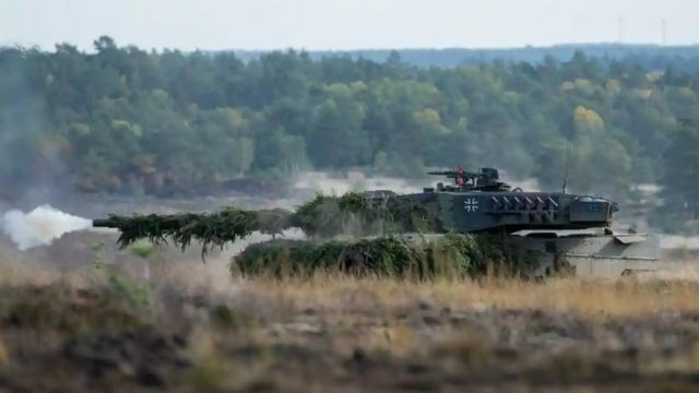 A German Leopard 2 tank fires during a maneuver in eastern Europe