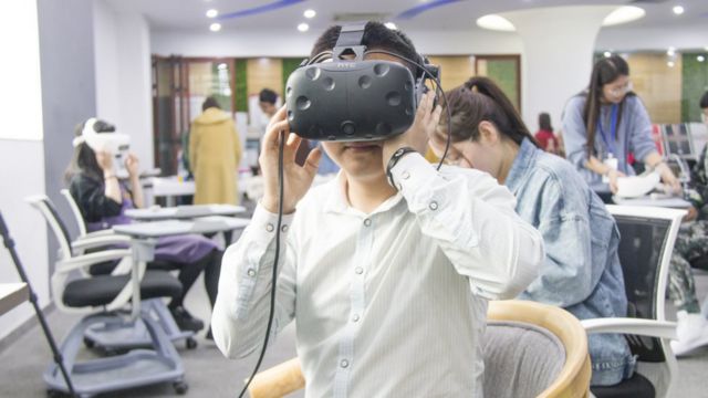 A man wears a virtual reality headset for the See For She experience.