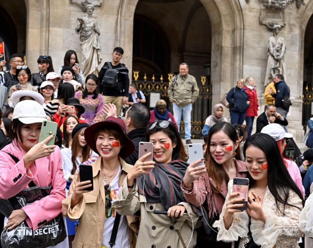 Chinese tourists take selfie in front of Opera Garnier in Paris, France on September 28, 2019