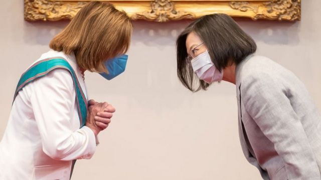 Nancy Pelosi and Taiwan's President Tsai Ing-wen bowing to each other