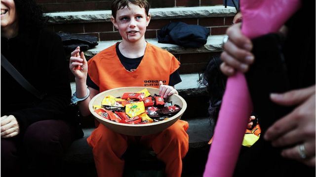 People trick-or-treat in a Brooklyn neighborhood on Halloween night on October 31, 2015 in New York City.