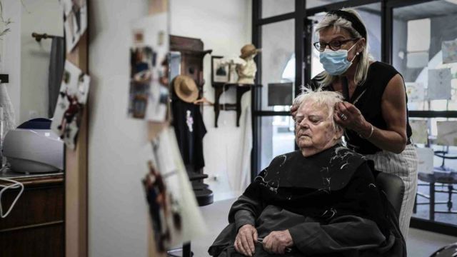 Alzheimer's patient gets a haircut at the Landais Village Alzheimer site for Alzheimer's patients in Dax, southwestern France