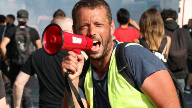 A protester shouts through a megaphone