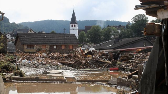 Collapsed houses are seen on a flood-affected area following heavy rainfalls in Schuld