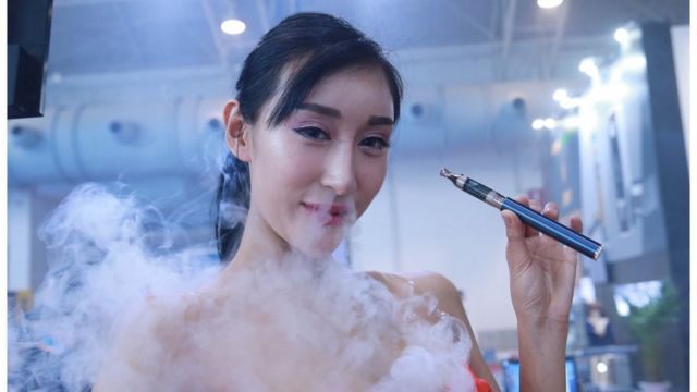 北京で開かれた中国国際電子タバコ展示会でデモンストレーションしてみせるモデル