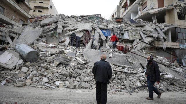 Rescuers work at the site of a collapsed building following an earthquake in Armanaz town, Idlib Governorate, Syria 06 February 2023.