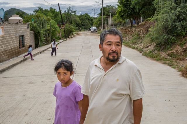 Guadalupe Flores, 45, his daughter Kimberly, 10, and other members of his family, walk through the streets of Acatlán, Puebla, Mexico, October 18, 2018