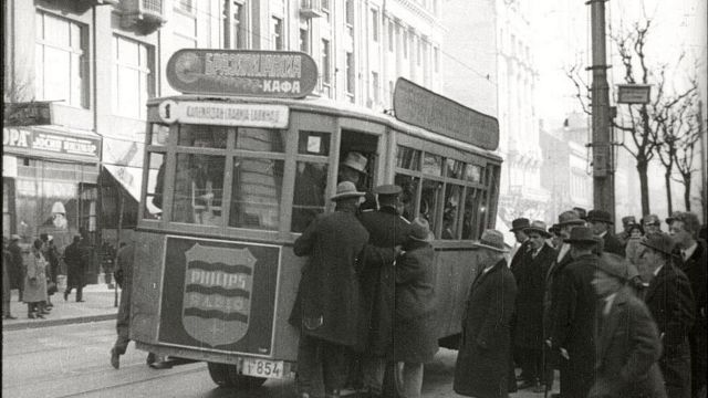 Putnici pokušavaju da se popnu u pun tranvaj, scena iz filma