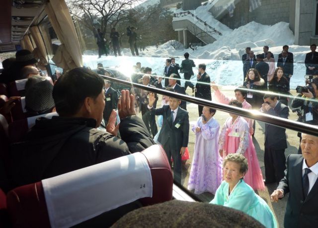 In a file photo taken on 22 February 2014 a South Korean man (L) waves to his North Korean relatives from the window of a bus following a family reunion at the resort area of Mount Kumgang, North Korea
