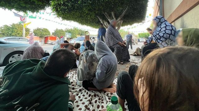 People shelter near the University of Palestine