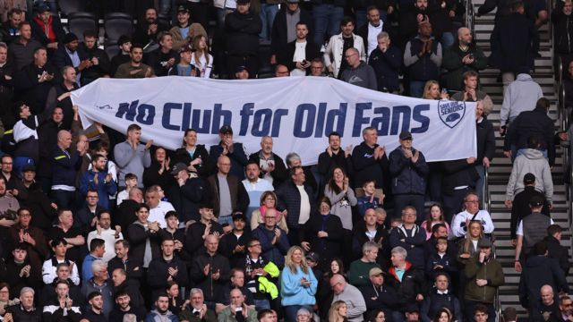 Spurs supporters hold up a protest banner