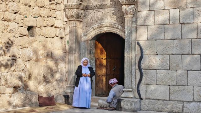 Entrada de templo no Curdistão - ao lado da porta, fachada tem imagem de cobra 