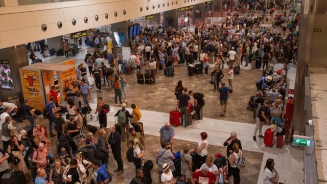 Passengers wait at Tenerife South Reina Sofia Airport after flights were cancelled due to a sandstorm