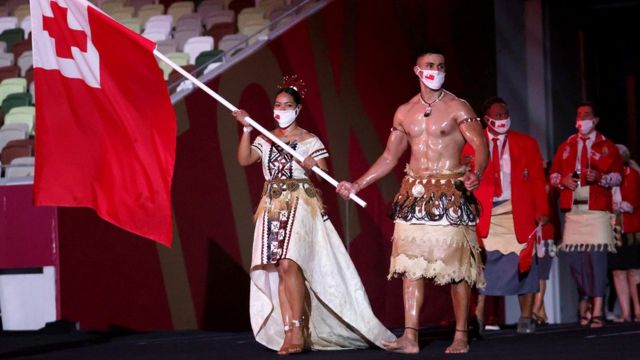 Flag bearers Malia Paseka and Pita Taufatofua of Team Tonga lead their team out during the Opening Ceremony of the Tokyo 2020 Olympic Games at Olympic Stadium on July 23, 2021 in Tokyo, Japan.
