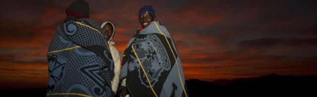 Men in Lesoth at dawn wearing traditional blankets