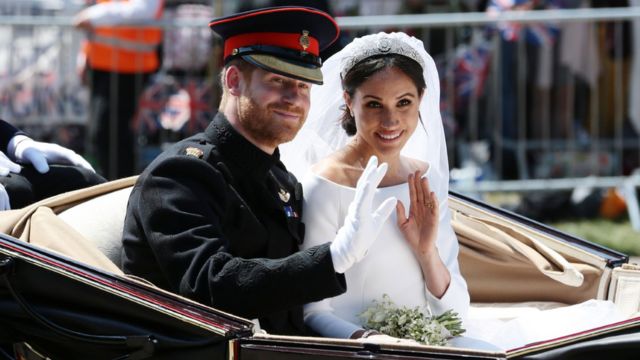 Harry and Meghan wave to the crowd from a carriage at their wedding in May 2018.