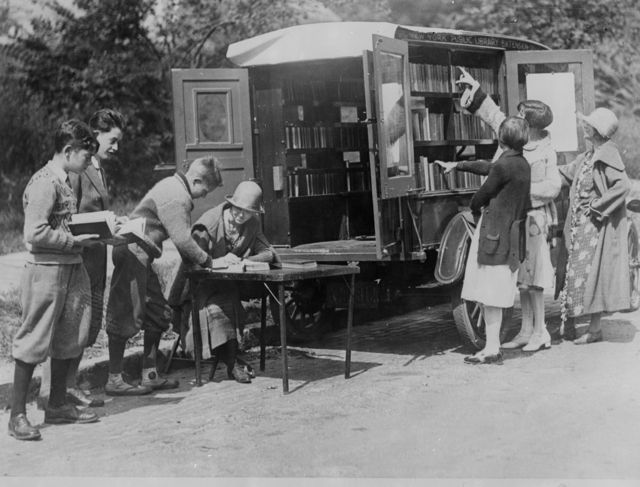 Old black and white photo of a mobile library, New York Public Library.