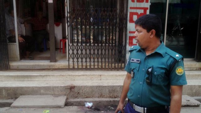 A Bangladeshi policeman stands guard at the site of the murder of a law student, hacked to death by four assailants the night before, in Dhaka on April 7, 2016