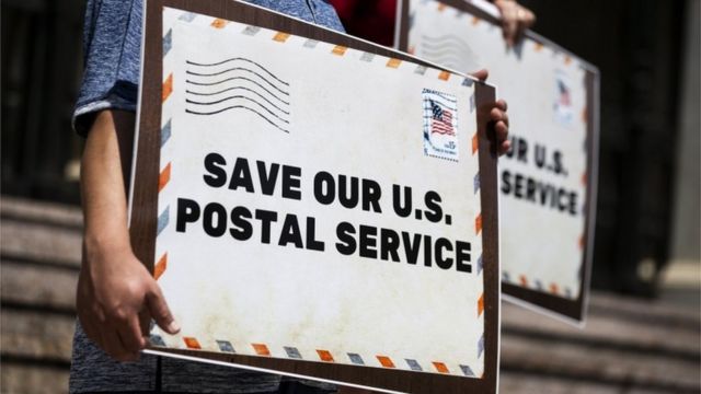 Protesters hold placards reading 'Save Our U.S. Postal Service' during a press conference in front of the Pasadena Post Office, in Pasadena, California, USA