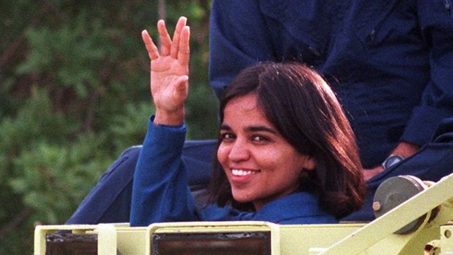 US space shuttle Columbia crewmember Doctor Kalpana Chawla, native of Karnal India, waves to the media 03 November from the drivers seat of an M-113 personnel carrier after a stint at driving the escape vehicle during crew training at Kennedy Space Center.