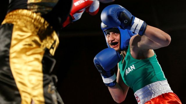 Iranian boxer Sadaf Khadem (R) beats the French boxer Anne Chauvin (L) in an amateur bout on 13 April 2019