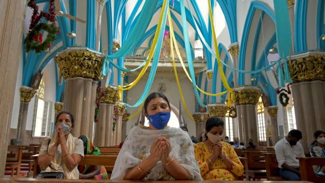 Christian devotees wearing facemasks as a preventive measure against the Covid-19 coronavirus offer prayers at St Marys Basilica on the eve of Christmas in Bangalore on December 24, 2020.