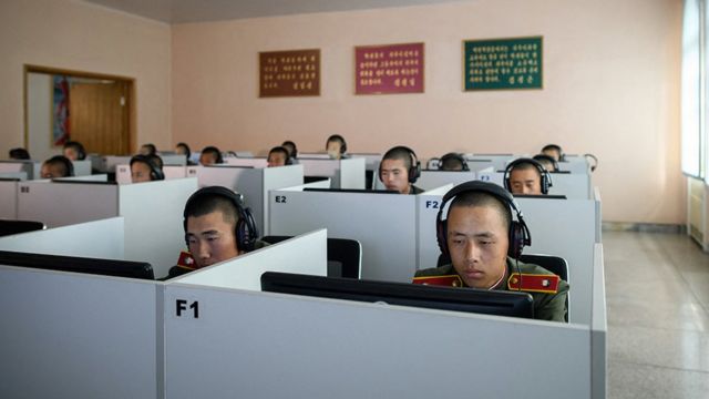 कम्प्युटर चलाउँदै कोरियाली पिपल्स आर्मीको पोसाक लगाएका विद्यार्थीहरू