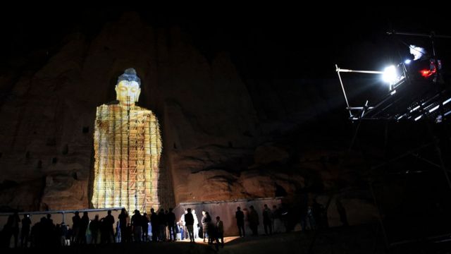 People watch a 3D projection of the 56 metre-high Salsal Buddha at the site where the Buddhas of Bamiyan statues stood before being destroyed by the Taliban in March 2001.